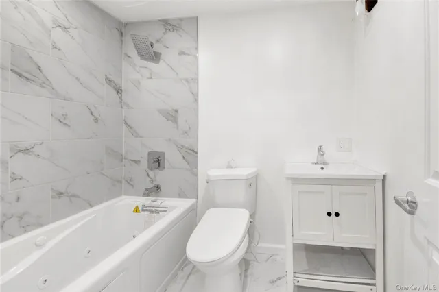 a bathroom with a bathtub toilet and sink