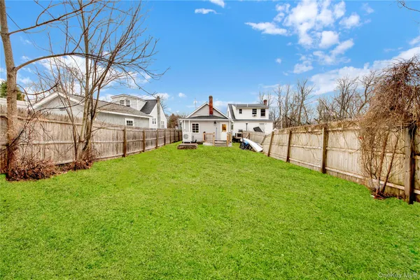 a view of a yard with large trees