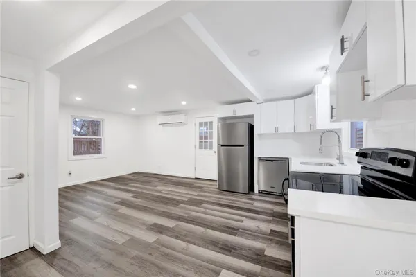 a kitchen with a refrigerator and a stove top oven