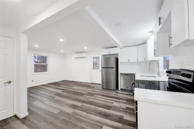 a kitchen with a refrigerator and a stove top oven