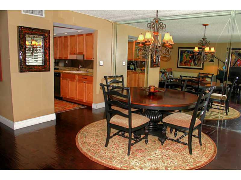 125 North Birch Road, Unit 107 Fort Lauderdale, FL 33304 - Photo 11 of 35 a dining room with furniture and wooden floor