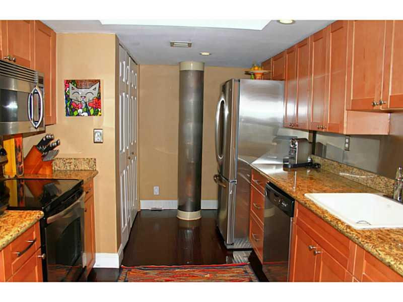 125 North Birch Road, Unit 107 Fort Lauderdale, FL 33304 - Photo 13 of 35 a kitchen with stainless steel appliances granite countertop a refrigerator and a sink