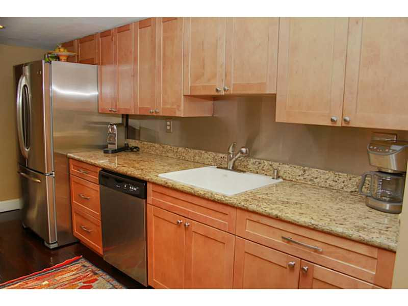 125 North Birch Road, Unit 107 Fort Lauderdale, FL 33304 - Photo 14 of 35 a kitchen with granite countertop a sink a stove and cabinets