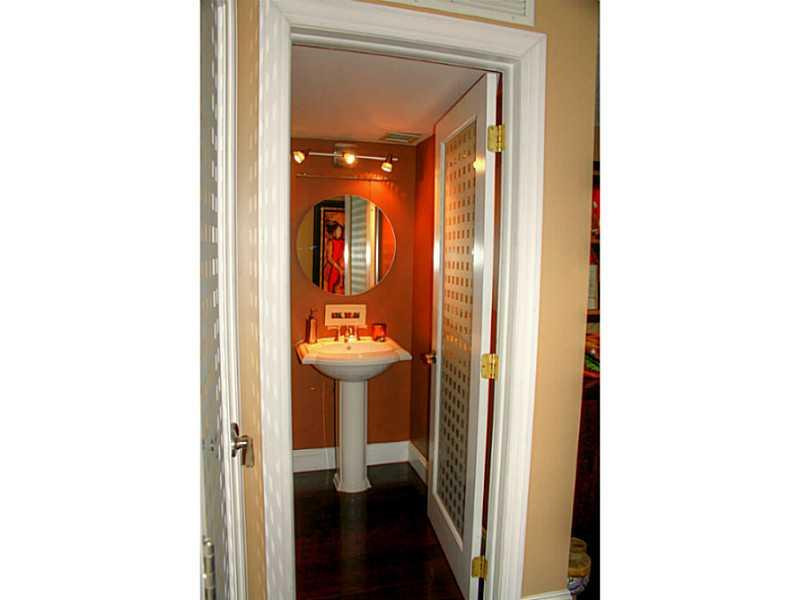 125 North Birch Road, Unit 107 Fort Lauderdale, FL 33304 - Photo 16 of 35 a view of a bathroom with a sink and a mirror