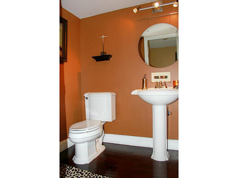 125 North Birch Road, Unit 107 Fort Lauderdale, FL 33304 - Photo 17 of 35 a bathroom with a toilet sink and mirror
