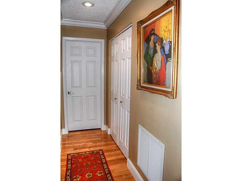 125 North Birch Road, Unit 107 Fort Lauderdale, FL 33304 - Photo 19 of 35 a view of a hallway with wooden floor and door