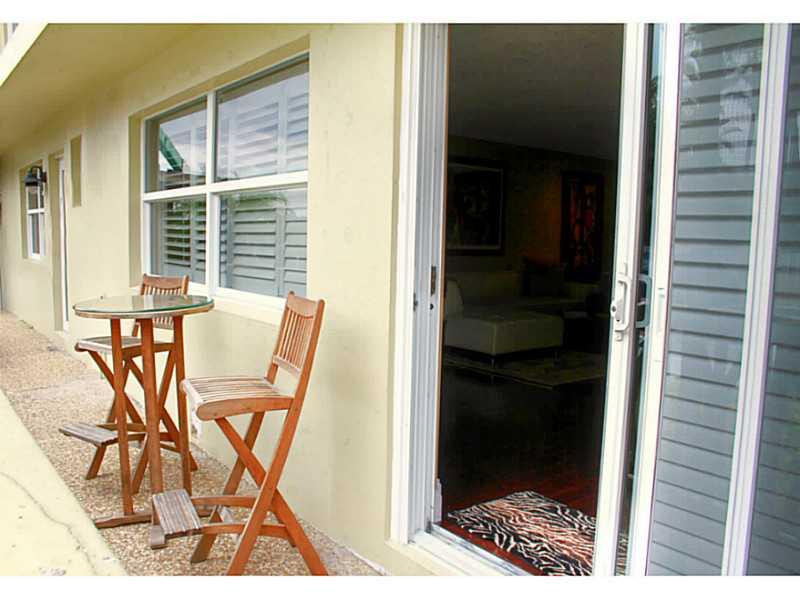 125 North Birch Road, Unit 107 Fort Lauderdale, FL 33304 - Photo 2 of 35 a picture of a room with a door and wooden floor