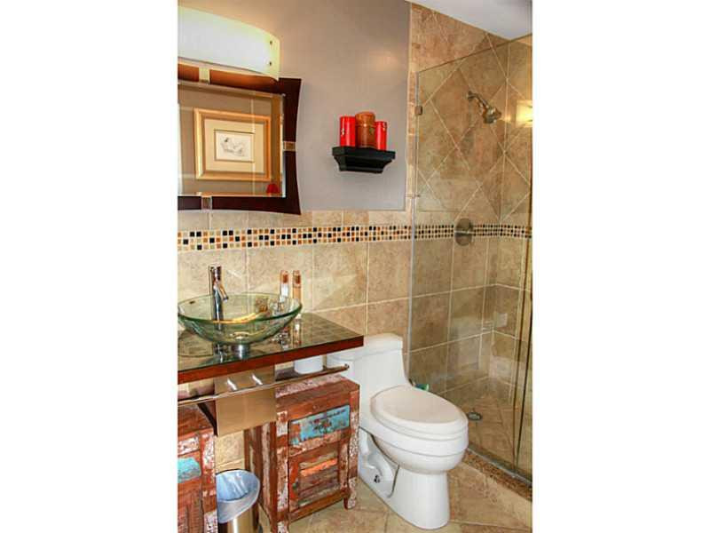 125 North Birch Road, Unit 107 Fort Lauderdale, FL 33304 - Photo 23 of 35 a bathroom with a toilet and a shower curtain