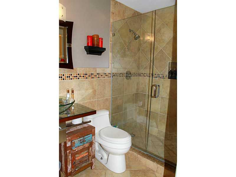 125 North Birch Road, Unit 107 Fort Lauderdale, FL 33304 - Photo 24 of 35 a bathroom with a toilet and a shower