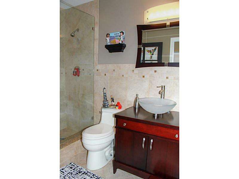 125 North Birch Road, Unit 107 Fort Lauderdale, FL 33304 - Photo 29 of 35 a bathroom with a sink toilet and mirror