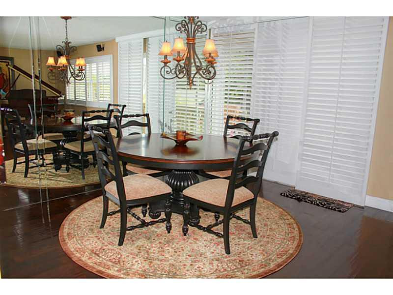 125 North Birch Road, Unit 107 Fort Lauderdale, FL 33304 - Photo 3 of 35 a dining room with furniture and wooden floor