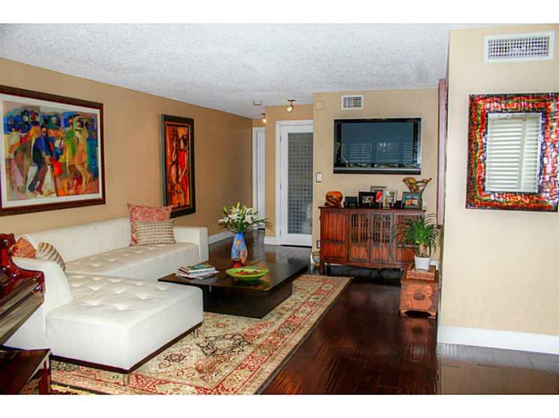 125 North Birch Road, Unit 107 Fort Lauderdale, FL 33304 - Photo 9 of 35 a living room with furniture and a flat screen tv