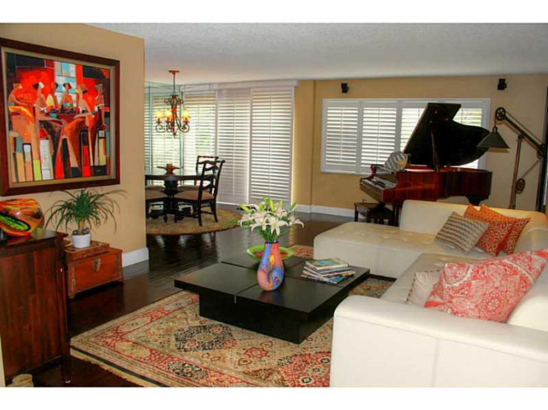 125 North Birch Road, Unit 107 Fort Lauderdale, FL 33304 - Photo 10 of 35 a living room with furniture and painting on the wall