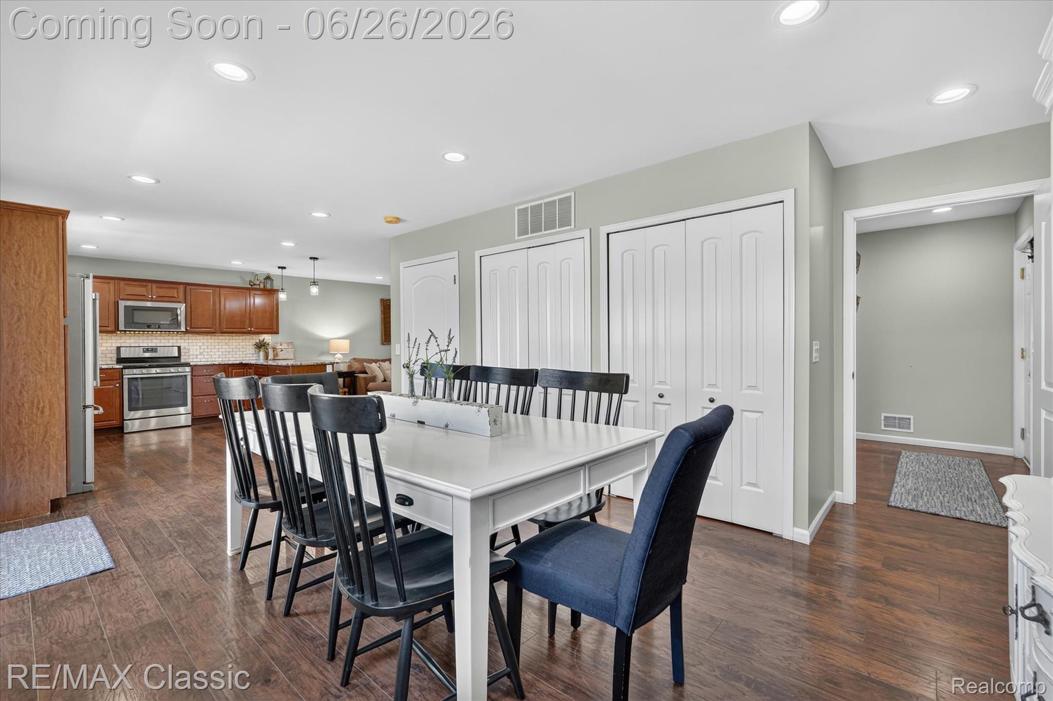 3205 North Milford Road Highland, MI 48357 - Photo 10 of 53 Open concept space featuring wood-finish flooring, recessed lighting, and a kitchen with stainless steel appliances