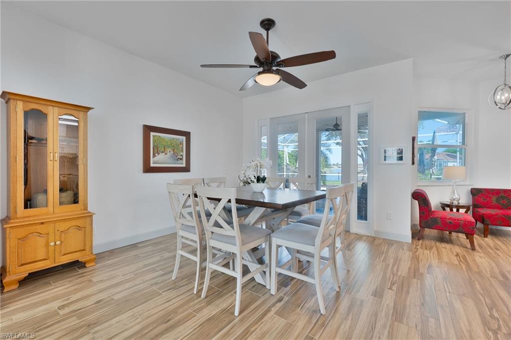3213 Brookeview Court Naples, FL 34120 - Photo 12 of 31 a view of a dining room with furniture and wooden floor