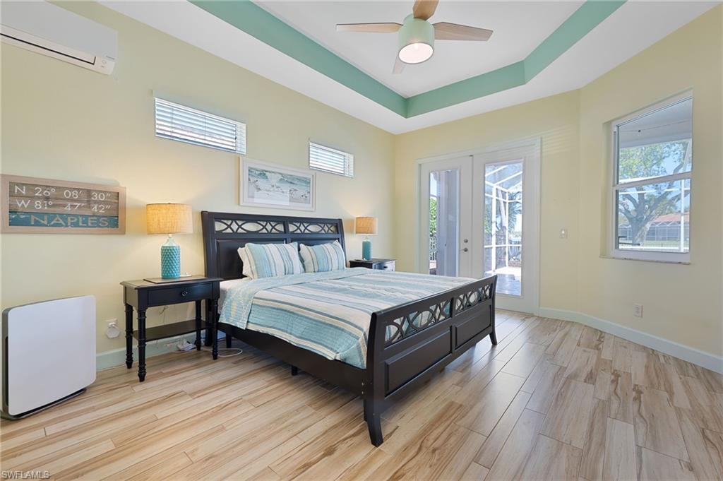 3213 Brookeview Court Naples, FL 34120 - Photo 13 of 31 a bedroom with a bed and a table