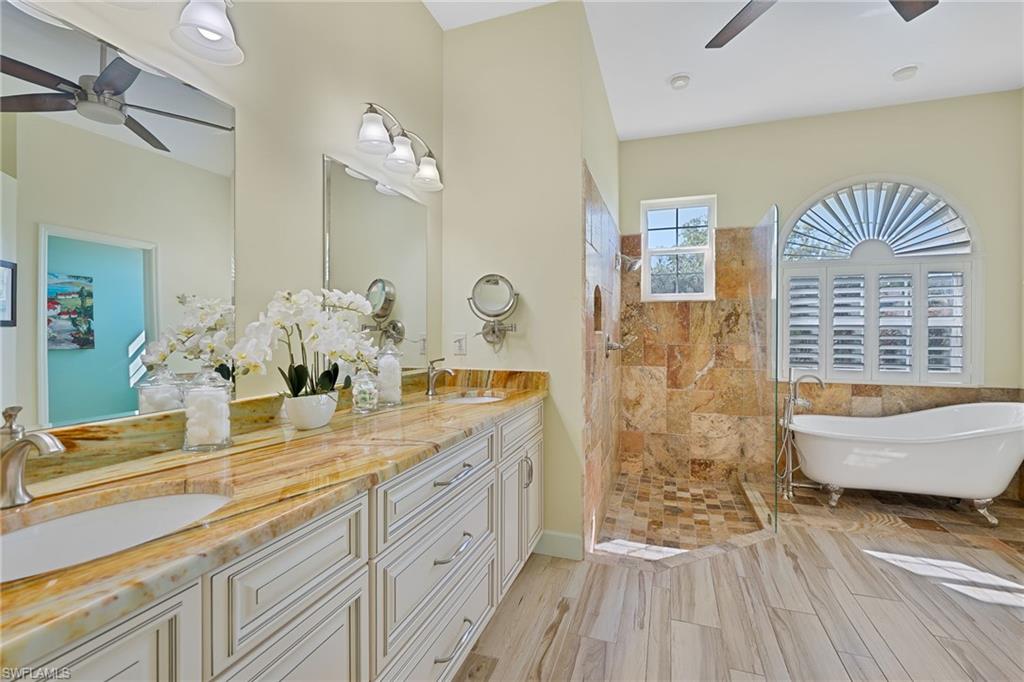 3213 Brookeview Court Naples, FL 34120 - Photo 14 of 31 a spacious bathroom with double vanity and a bathtub