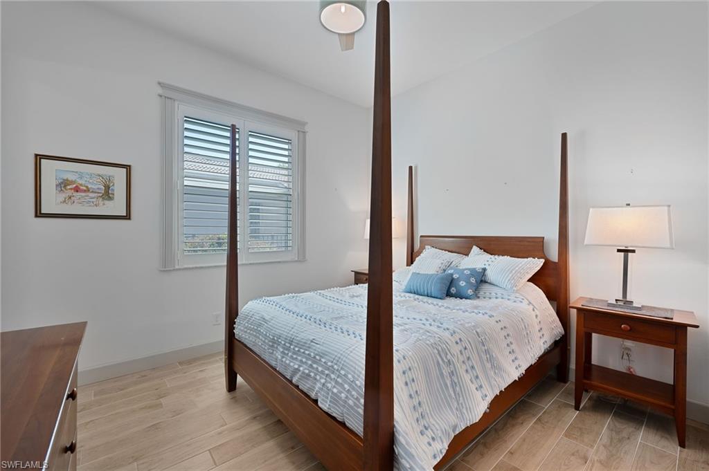 3213 Brookeview Court Naples, FL 34120 - Photo 15 of 31 a bedroom with a bed and a night stand