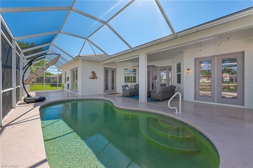 3213 Brookeview Court Naples, FL 34120 - Photo 20 of 31 a swimming pool with outdoor seating and yard