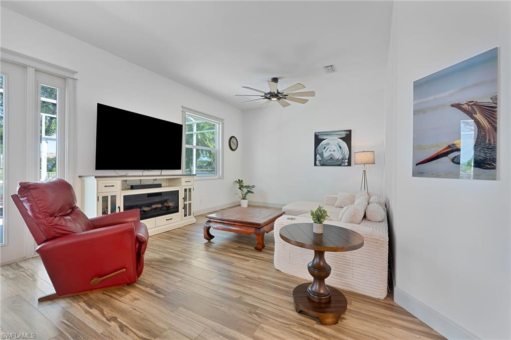3213 Brookeview Court Naples, FL 34120 - Photo 10 of 31 a living room with furniture and a flat screen tv
