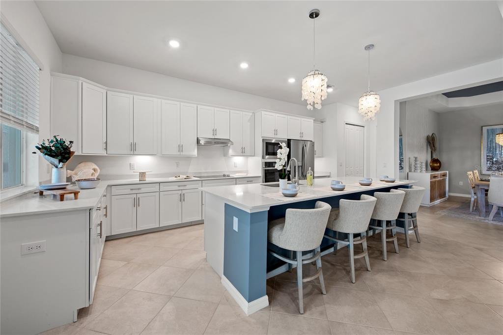 7161 Inlet Isles Lakewood Ranch, FL 34202 - Photo 7 of 29 a kitchen with a sink window and cabinets