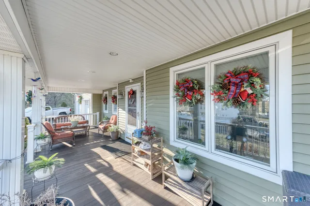 a living room with furniture a fireplace a flat screen tv and a large window