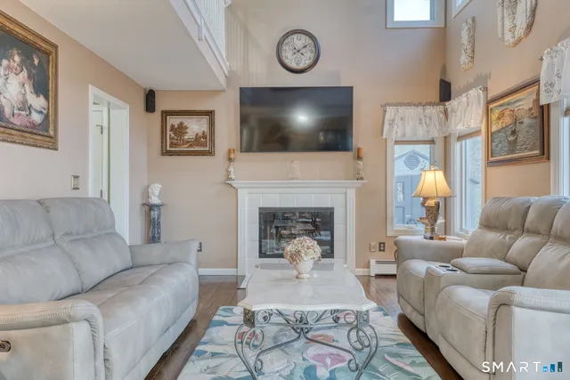 a view of a dining room and livingroom with furniture window and wooden floor