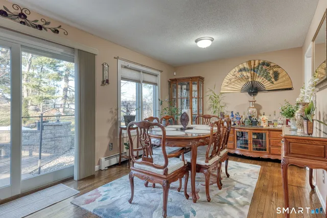 a kitchen with stainless steel appliances granite countertop table chairs sink and cabinets
