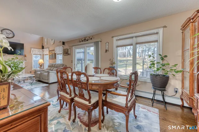 a bathroom with a granite countertop sink mirror and toilet