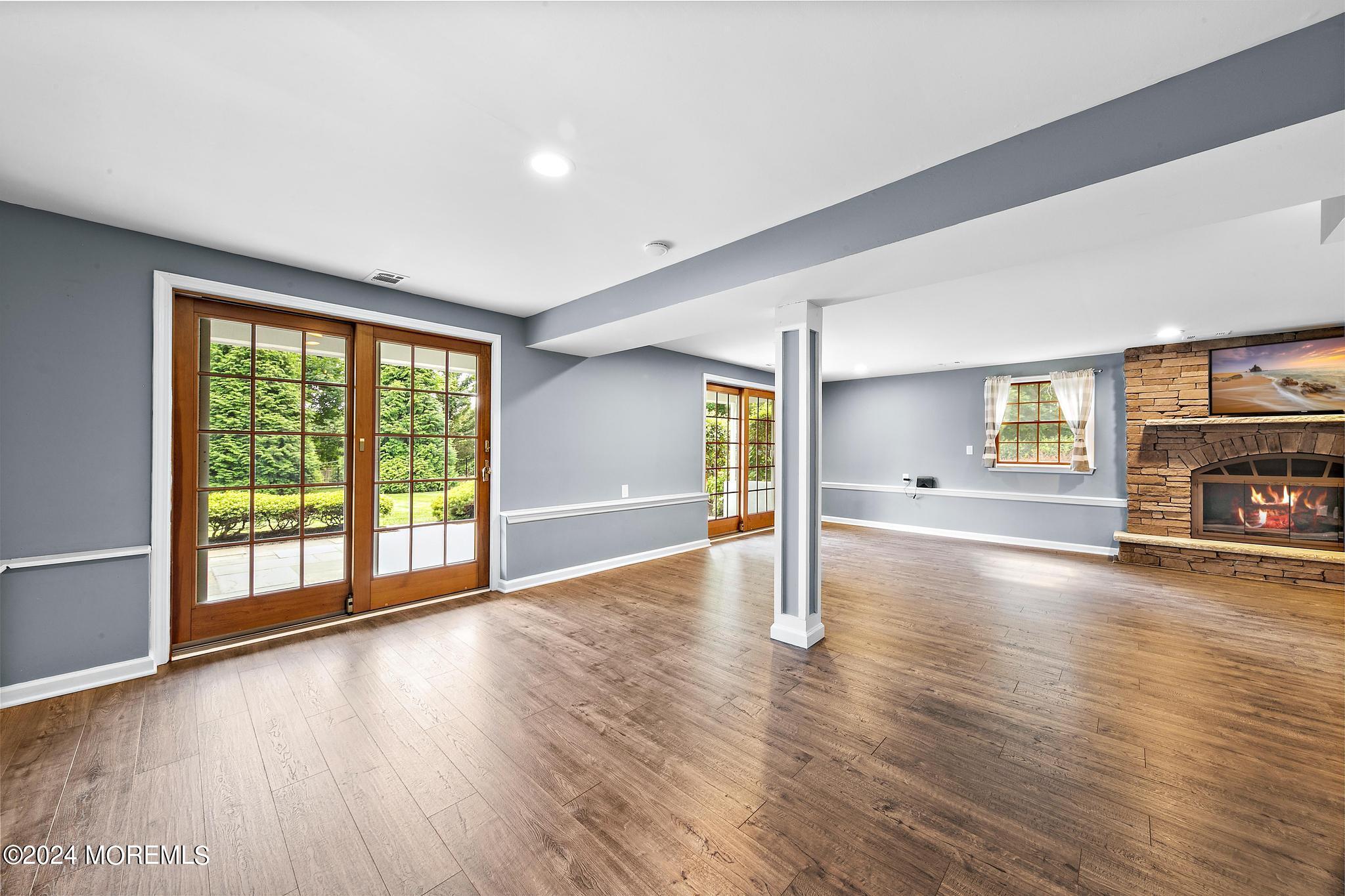27 Ivy Hill Road Red Bank, NJ 07701 - Photo 16 of 55 a view of empty room with wooden floor and fireplace