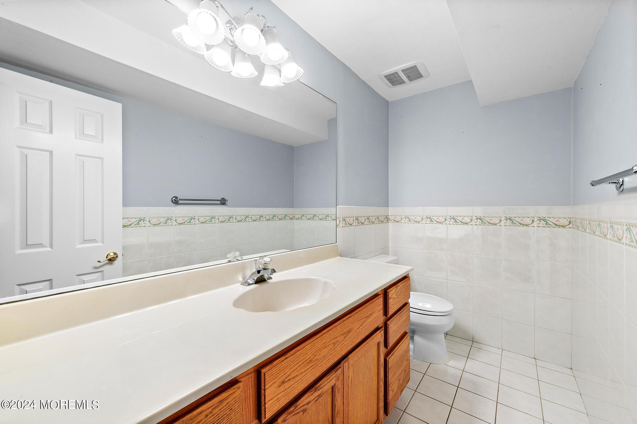 27 Ivy Hill Road Red Bank, NJ 07701 - Photo 17 of 55 a bathroom with a sink a toilet and a mirror