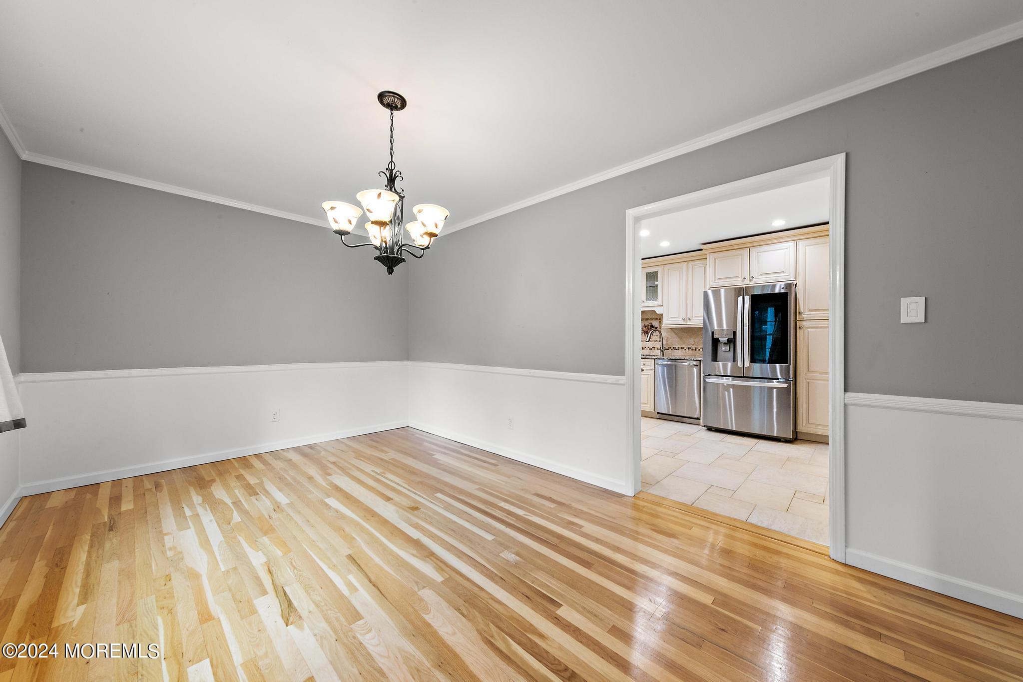 27 Ivy Hill Road Red Bank, NJ 07701 - Photo 18 of 55 a view of a livingroom with wooden floor and a chandelier