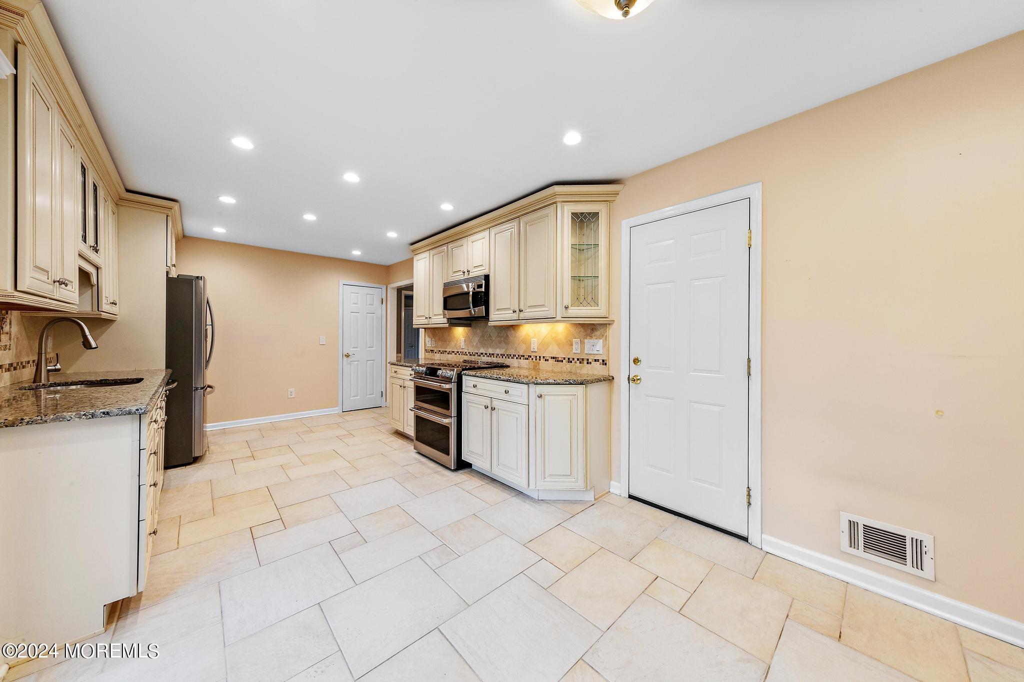 27 Ivy Hill Road Red Bank, NJ 07701 - Photo 25 of 55 a kitchen with stainless steel appliances granite countertop a refrigerator and a stove top oven