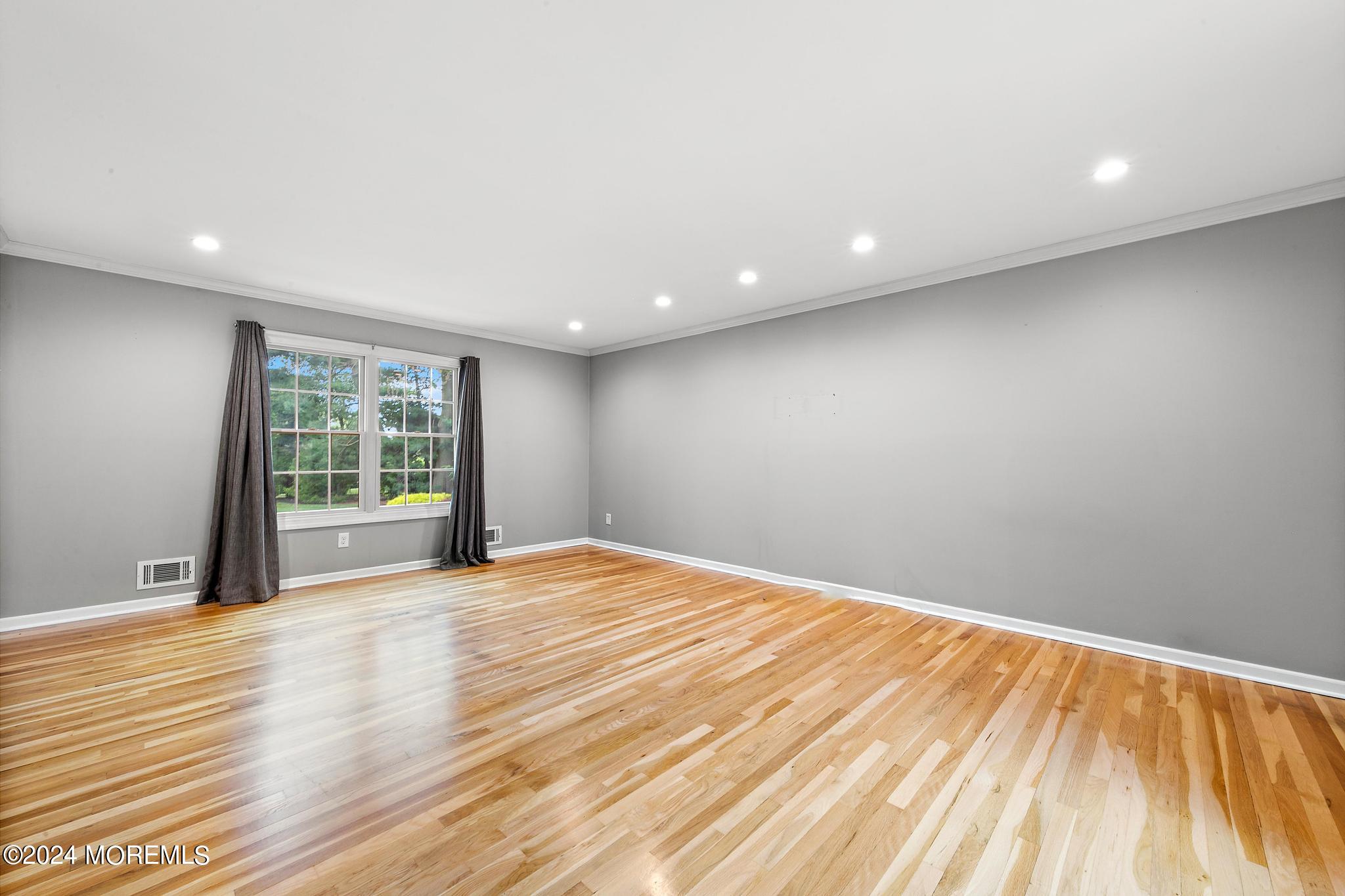 27 Ivy Hill Road Red Bank, NJ 07701 - Photo 26 of 55 a view of an empty room with wooden floor and a window