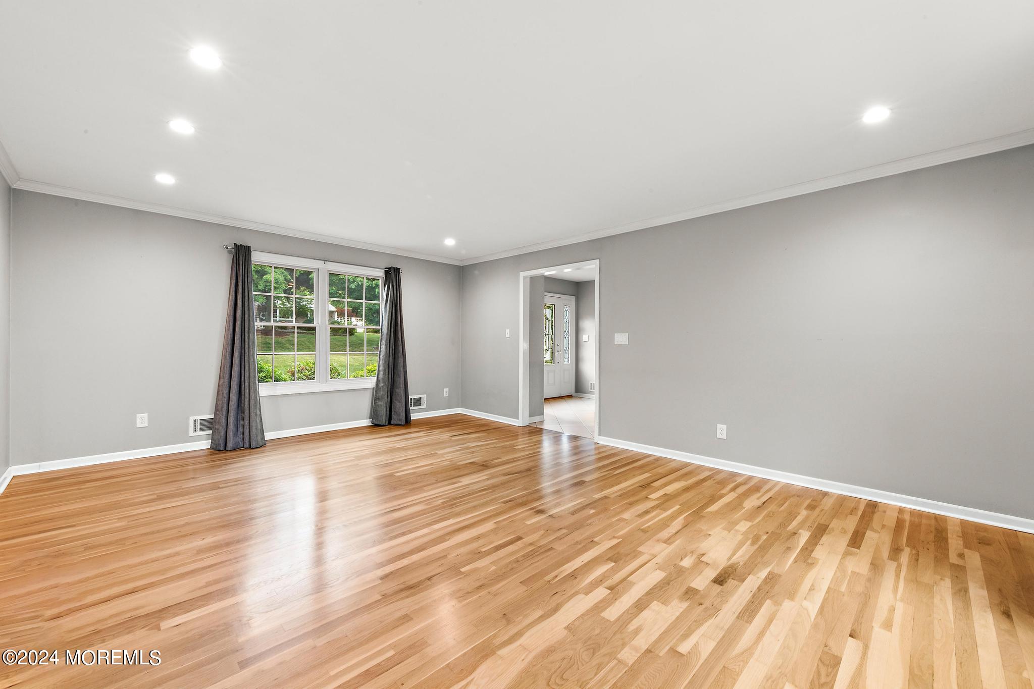 27 Ivy Hill Road Red Bank, NJ 07701 - Photo 28 of 55 a view of an empty room with wooden floor and a window