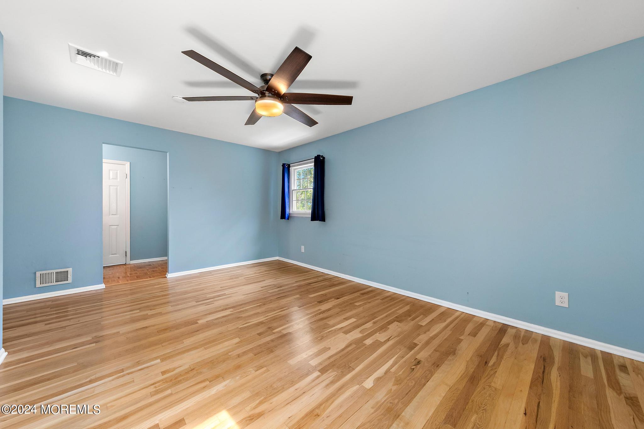 27 Ivy Hill Road Red Bank, NJ 07701 - Photo 30 of 55 a view of an empty room with window and wooden floor