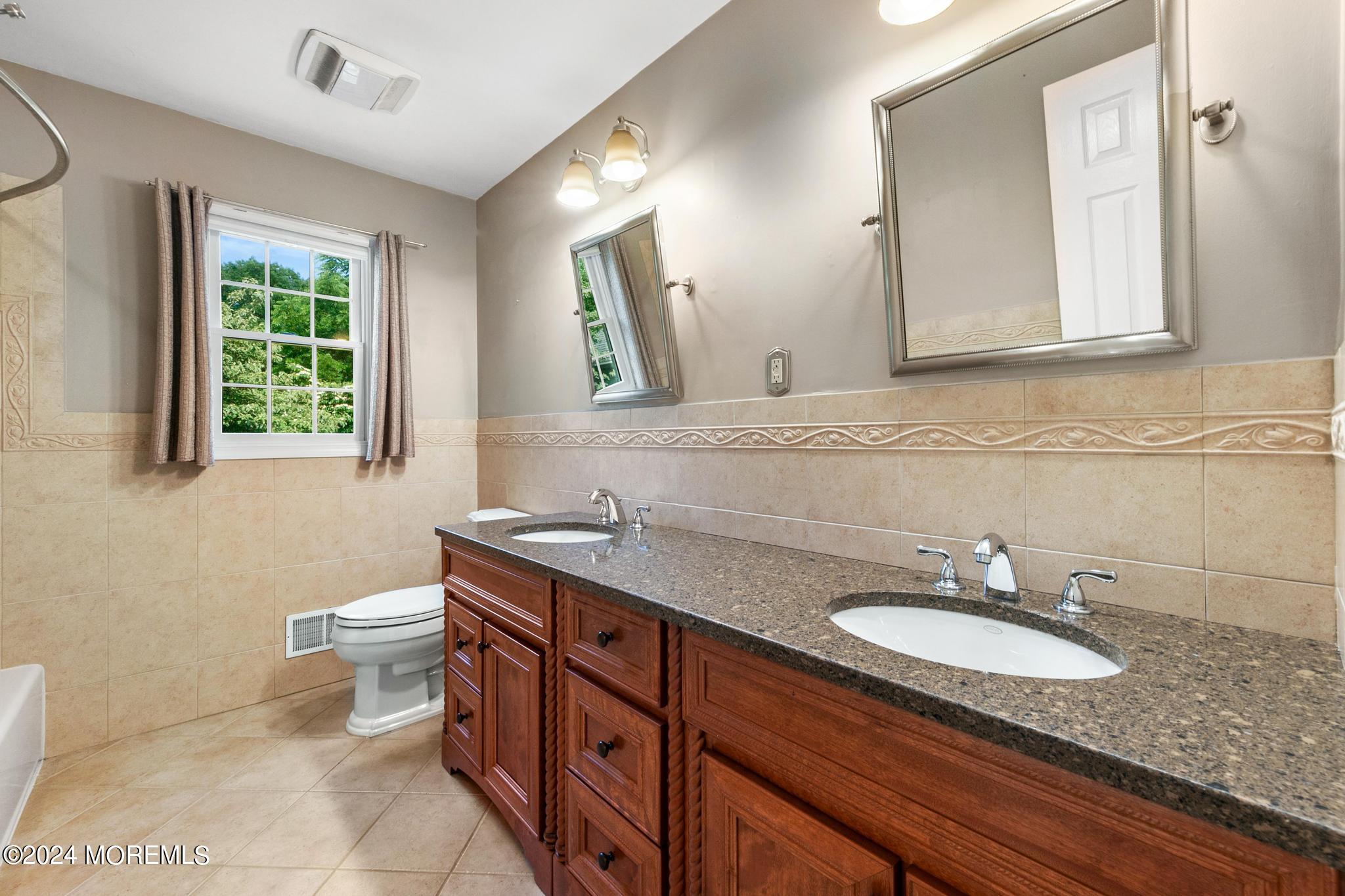 27 Ivy Hill Road Red Bank, NJ 07701 - Photo 40 of 55 a bathroom with a granite countertop sink a toilet and mirror