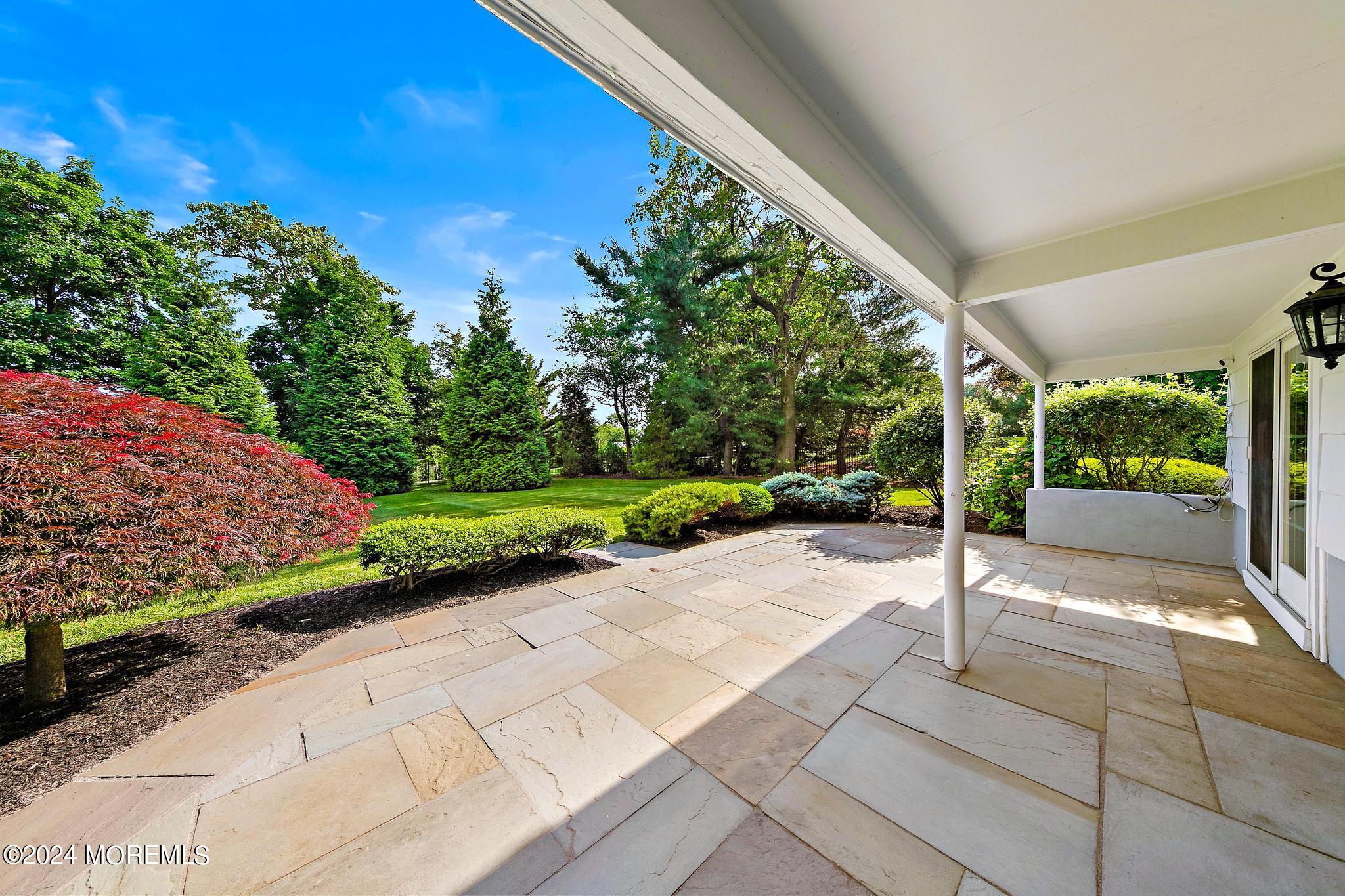 27 Ivy Hill Road Red Bank, NJ 07701 - Photo 47 of 55 a view of a patio with a table and chairs under an umbrella