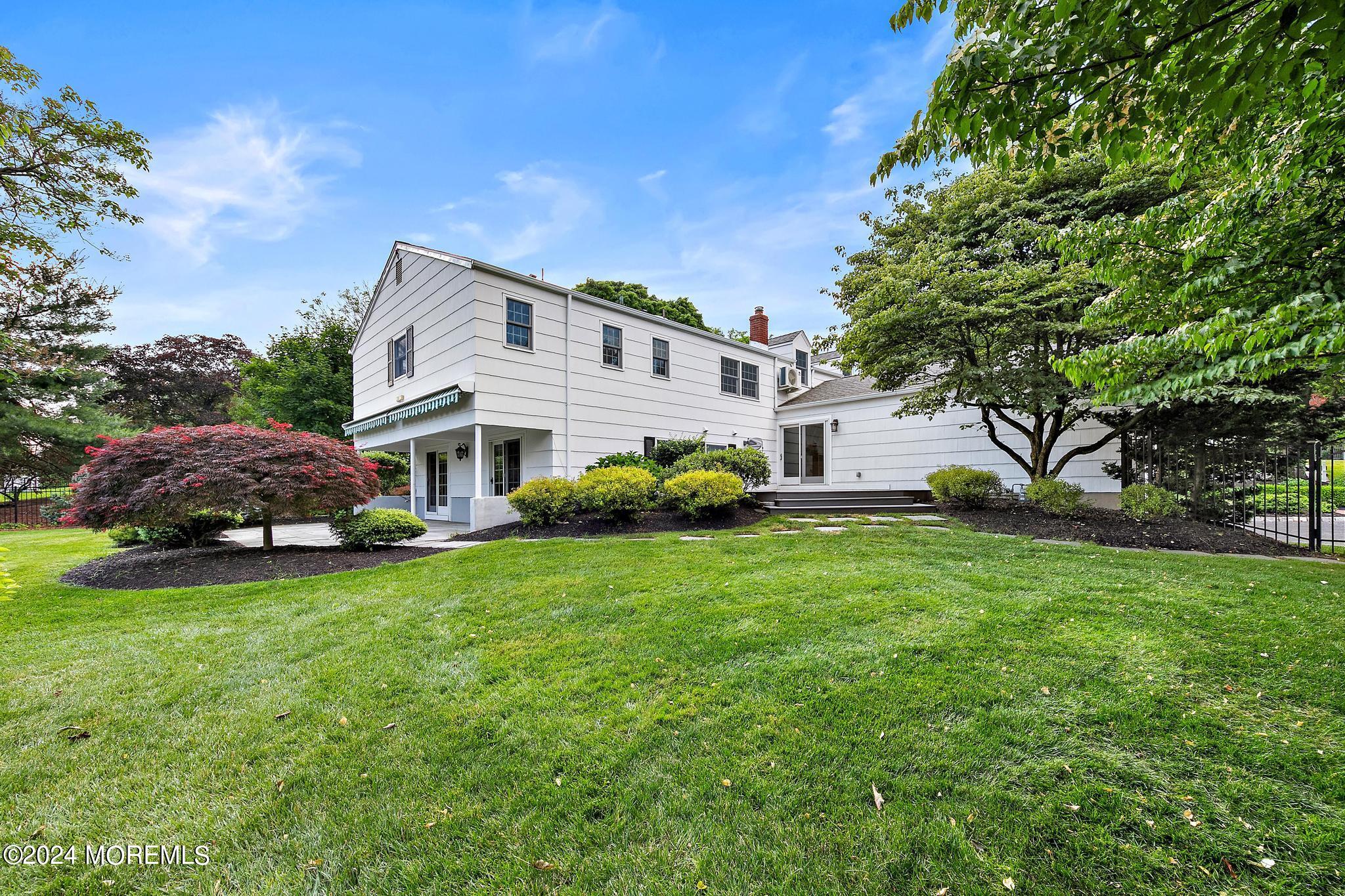 27 Ivy Hill Road Red Bank, NJ 07701 - Photo 53 of 55 a front view of a house with a garden and trees