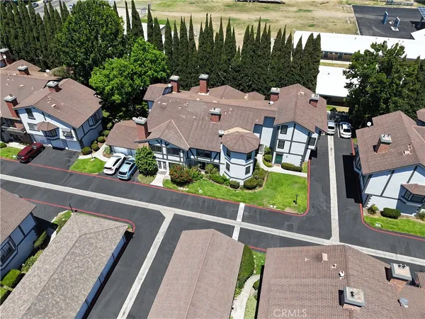 an aerial view of a house with garden space and street view