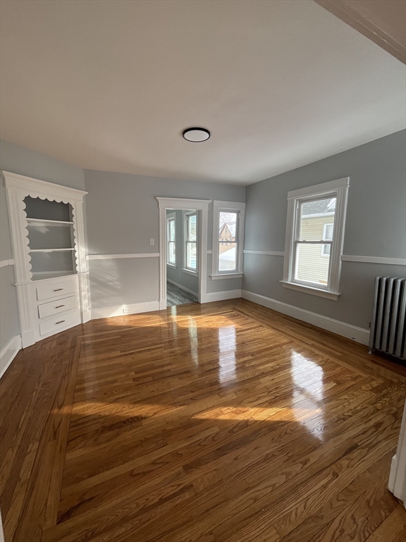 25 Malden Street, Unit 2 Springfield, MA 01108 - Photo 4 of 10 a view of empty room with window and wooden floor