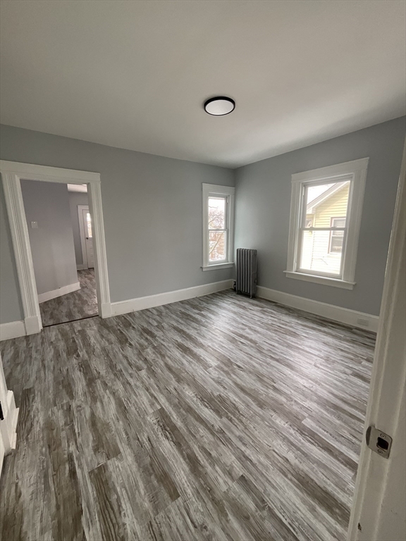 25 Malden Street, Unit 2 Springfield, MA 01108 - Photo 6 of 10 a view of empty room with wooden floor and fan