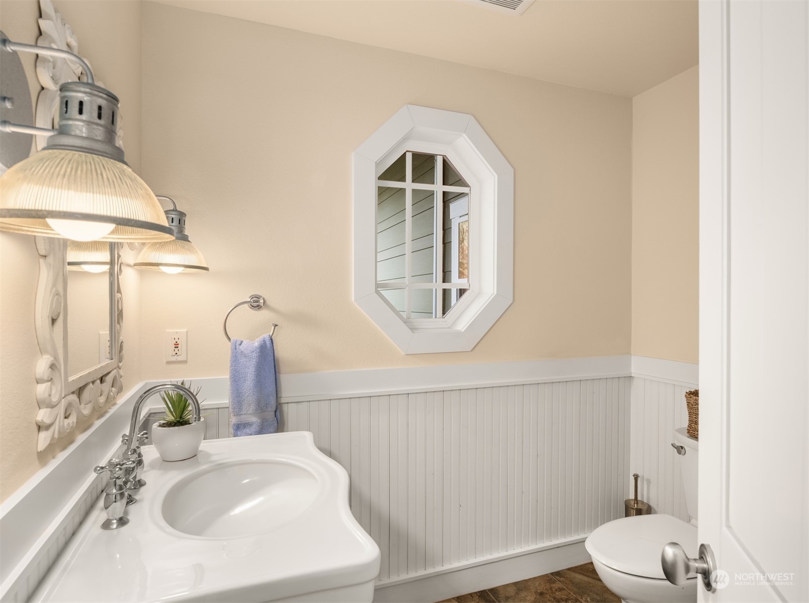 4860 East Harbor Road Freeland, WA 98249 - Photo 23 of 36 a bathroom with a sink a toilet and mirror