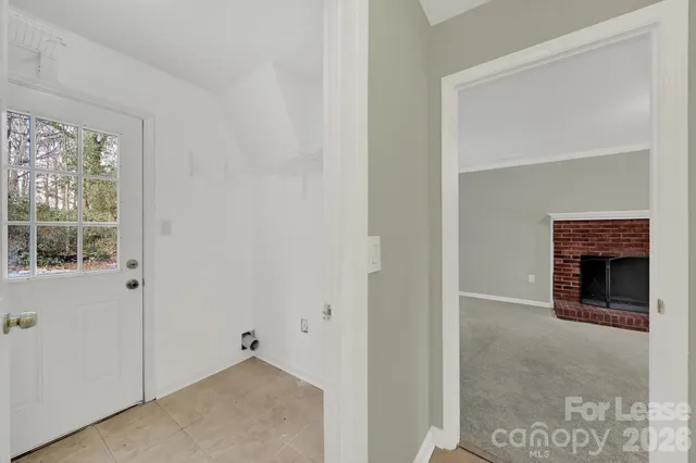 a view of empty room with a fireplace