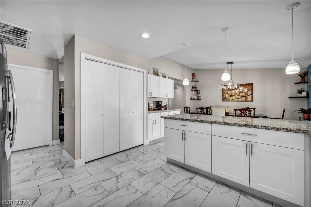 5882 Rio Tinto Way Las Vegas, NV 89110 - Photo 29 of 56 A well-appointed kitchen boasts sleek countertops and modern cabinetry, creating an inviting culinary space.
