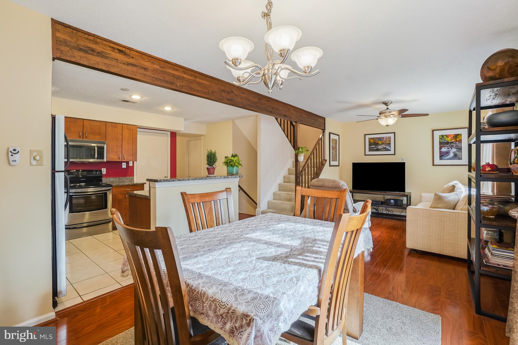 2315 Glade Bank Way Reston, VA 20191 - Photo 13 of 52 a view of a dining room with furniture a kitchen and chandelier