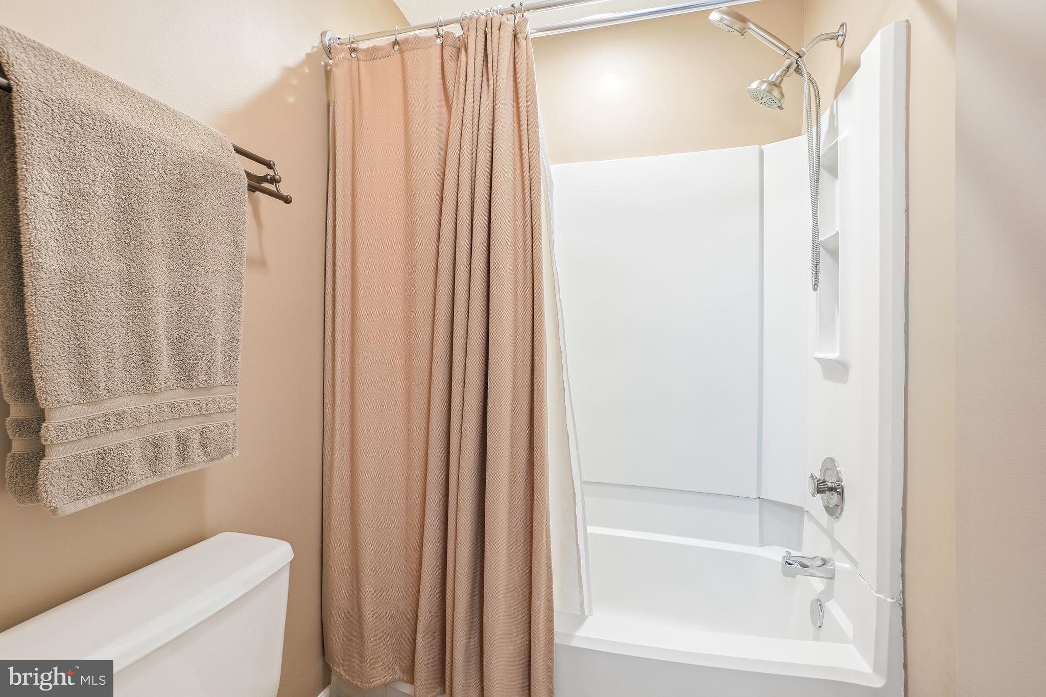 2315 Glade Bank Way Reston, VA 20191 - Photo 29 of 52 a bathroom with a shower curtain and a toilet