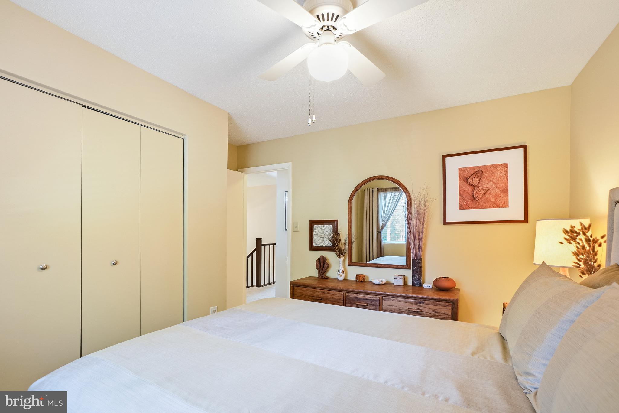 2315 Glade Bank Way Reston, VA 20191 - Photo 33 of 52 a bedroom with a bed and a dresser next to a window