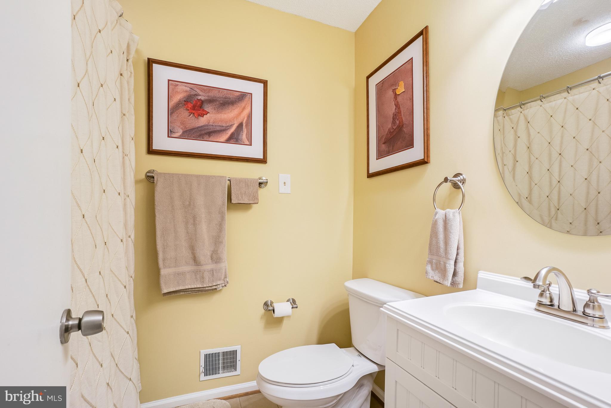 2315 Glade Bank Way Reston, VA 20191 - Photo 35 of 52 a bathroom with a toilet sink and mirror