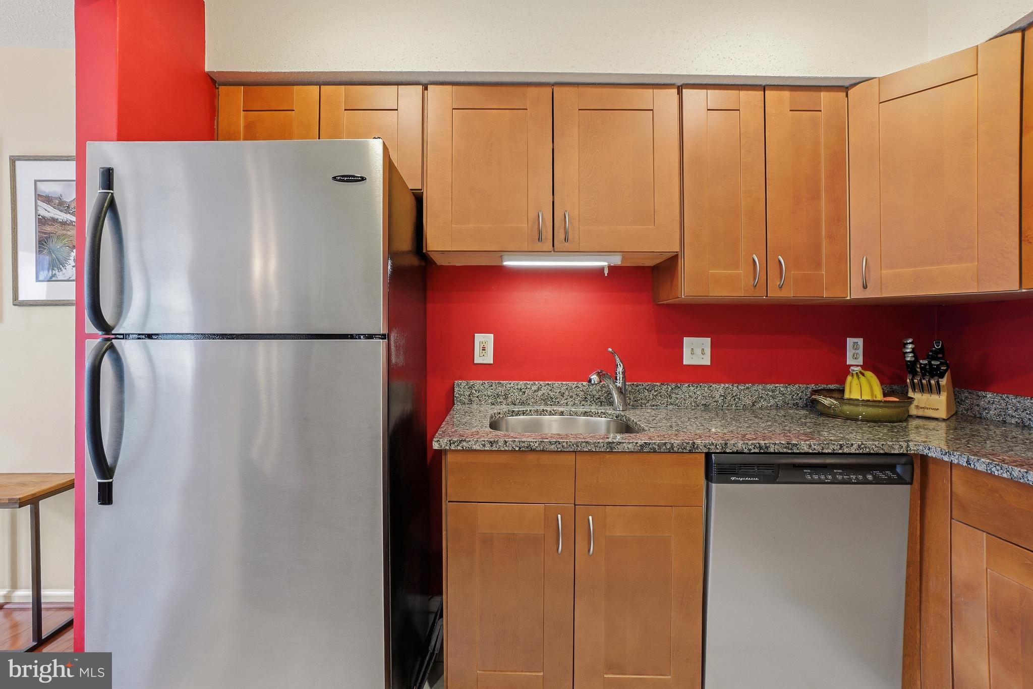 2315 Glade Bank Way Reston, VA 20191 - Photo 6 of 52 a white refrigerator freezer sitting in a kitchen